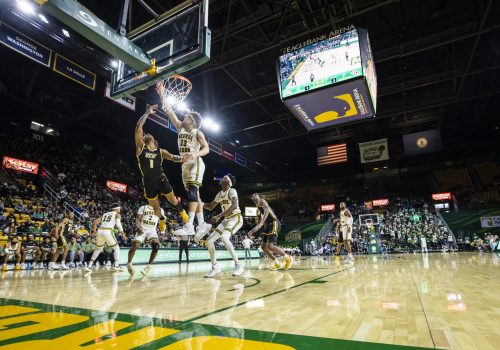 Mason Men's basketbal team player shown going in for a close shot at the basketball hoop